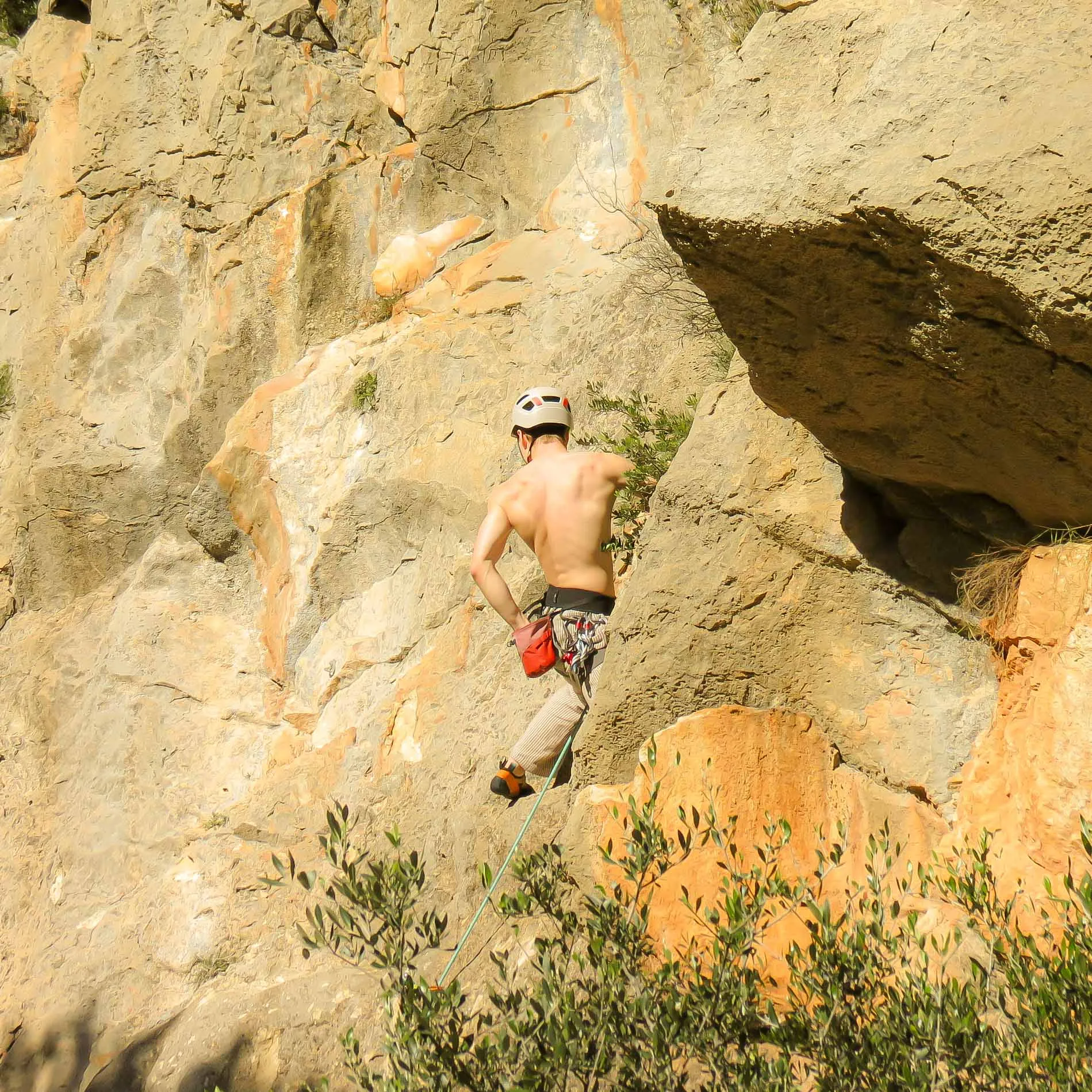 Climbing on a warm rock face under a blue sky
